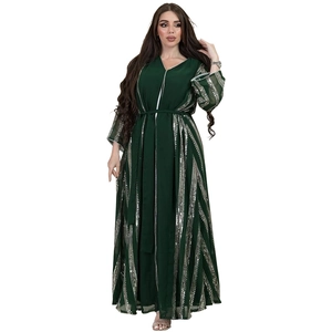 Close-up of sparkling silver sequins and striped patterns on a green chiffon abaya robe