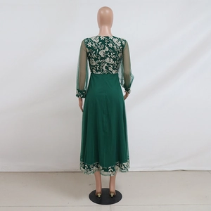 Detail of gold floral embroidery on dark green mesh sleeve and back of the kaftan dress