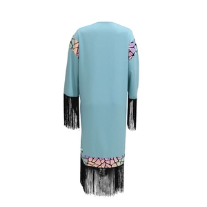 Close-up of light blue robe with iridescent sequins and black tassel hem detail