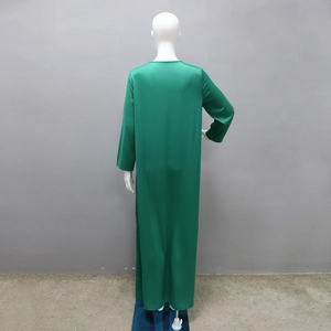 Rear view of long green satin maxi dress showing smooth texture and loose flowy fit