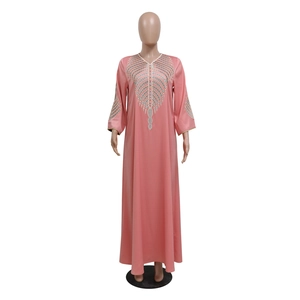 Detailed close-up of colorful geometric embroidery on a pink Kaftan long-sleeved dress