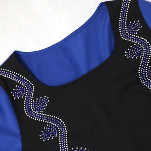 Detail of crystal rhinestones on color-block kaftan dress with intricate vine patterns