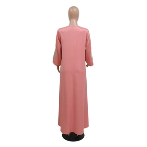 Detail view of pink long kaftan dress featuring colorful wavy embroidery on the sleeves