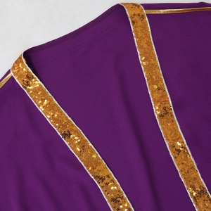 Dettaglio di un abito viola con bordo di paillettes dorate e trama del tessuto liscio