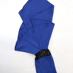 Detailed view of royal blue kaftan dress featuring black lace trim and ruffled sleeves