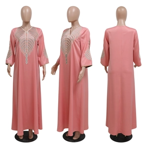 Detailed view of pink kaftan dress with colorful embroidery on V-neck and sleeves