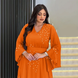Detail of orange chiffon kaftan with elegant pearl beading on V-neck and ruffled cuffs