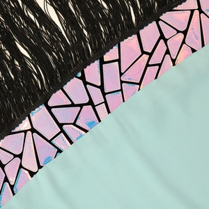 Detailed close-up of sequin tassels and geometric holographic patterns on a mint green dress