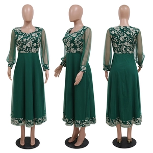 Detail of dark green kaftan dress featuring white floral embroidery and sheer lantern sleeves