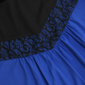 Detail of black floral lace trim joining blue pleated chiffon and black fabric on dress