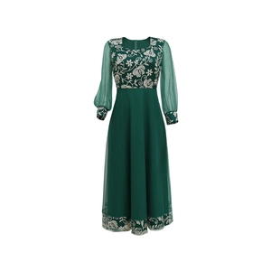 Detail of elegant dark green kaftan dress featuring white floral embroidery and mesh sleeves