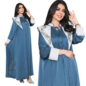 Detail of sequin embroidery on white collar and sleeve of navy satin jalabiya dress