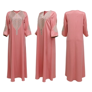 Detail of colorful geometric embroidery on the V-neck of a pink kaftan maxi dress