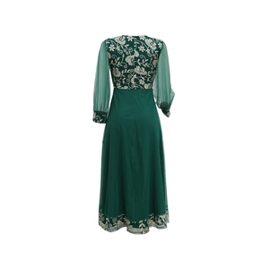 Detailed embroidery and sheer mesh sleeves of a dark green kaftan long dress