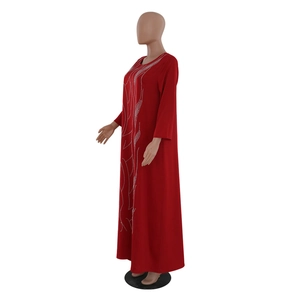 Detailed view of the sparkling rhinestone curved patterns on this red maxi dress