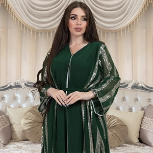 Detailed close-up of dark green chiffon kaftan with silver sequin stripes and V-neckline