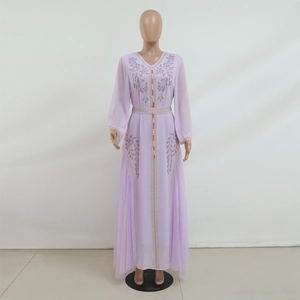 Detail of lavender mesh dress featuring intricate rhinestone floral patterns and pleats