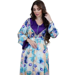 Detail view of ethnic floral dress with beaded V-neckline and purple satin trims
