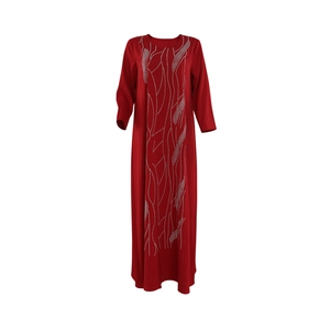 Detailed view of silver rhinestone wavy feather pattern on a long red dress