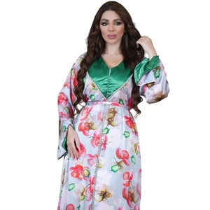 Close-up of floral print kaftan dress featuring green satin V-neck and handmade buttons