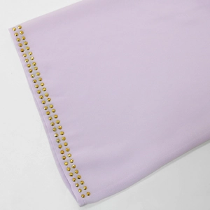 Detail view of lavender mesh dress sleeve featuring double-row gold rhinestone accents