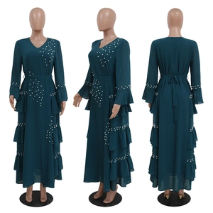 Detail of beaded pearls and ruffled layers on a teal green chiffon maxi dress