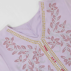 Detail of V-neckline with red rhinestones and beaded patterns on light purple mesh dress