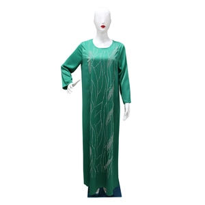 Detail of green long-sleeved abaya dress with elegant silver beaded flowing line patterns