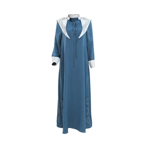 Close-up of laser-cut hollow details on blue jalabiya dress with white trim accents