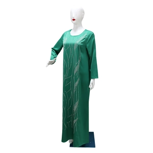 Detail of emerald green satin maxi dress with vertical silver wavy rhinestone trim