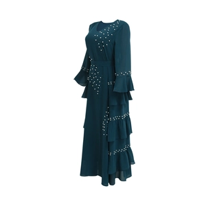 Detailed view of dark green chiffon maxi dress with pearl beading and flared sleeves