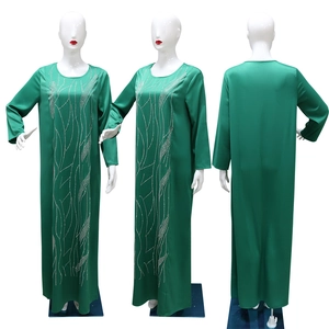 Detailed views of dark green loose Abaya dress with elegant silver rhinestone patterns