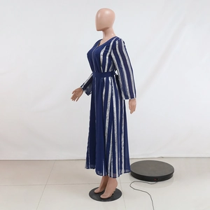 Detailed view of striped sequin chiffon fabric with silver vertical lines on a blue dress