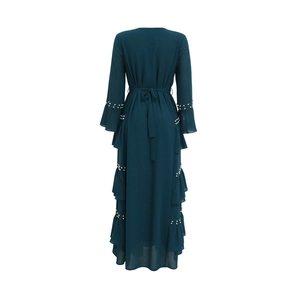 Detailed view of layered ruffles and white pearl beading on dark green chiffon abaya