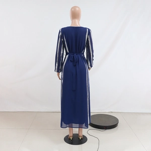 Rear view of dark blue chiffon maxi dress with silver striped panels and waist tie