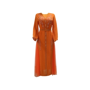 Detail of orange V-neck kaftan with silver sequins, beads and sheer mesh patchwork panels