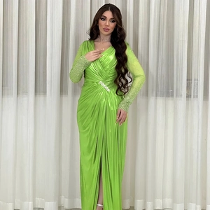 Detail of neon green satin evening gown with beaded sleeves and waist rhinestone buckle