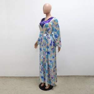 Detail of floral printed satin robe dress with beaded V-neckline and lace trim sleeves