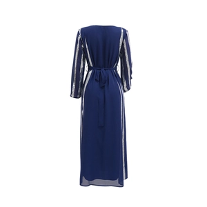 Back view of a navy blue chiffon maxi dress featuring silver sequin stripes and a waist bow