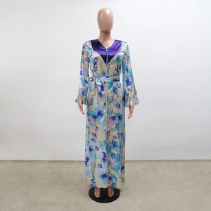 Detail of V-neckline with teal buttons and lace trim on a floral kaftan dress