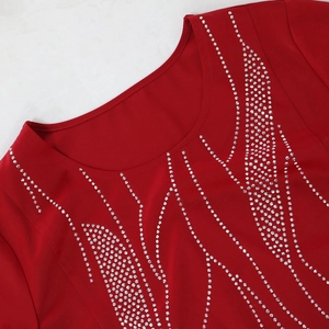 Close-up of red maxi dress neckline with elegant rhinestone flame patterns and round collar