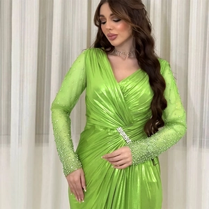 Lime green evening gown with deep V-neck, cinched waist, and pearl embellished mesh sleeves
