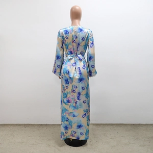 Detail of floral maxi dress featuring back waist bow tie and delicate beaded sleeve cuffs
