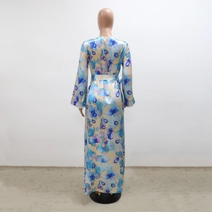 Detail of elegant satin floral dress featuring intricate butterfly prints and waist tie