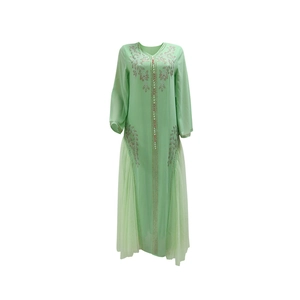 Close-up of mint green kaftan dress featuring v-neck and intricate floral rhinestone detailing