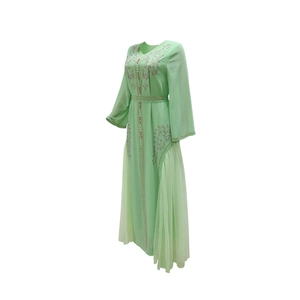 Detailed view of mint green mesh dress featuring exquisite sequin floral patterns