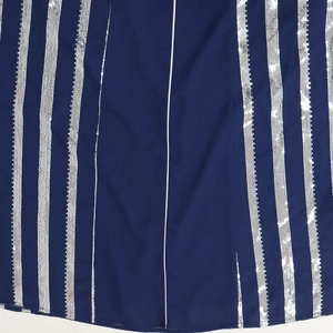 Close-up of deep blue chiffon fabric with vertical silver sequin stripe detailing