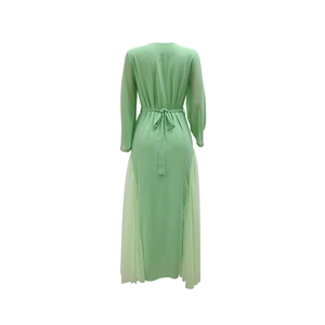 Detail view of mint green dress back with waist bow tie and sheer pleated mesh inserts