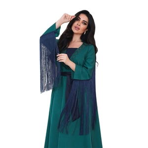 Detailed view of dark green abaya featuring long blue tassels and diamond embroidery