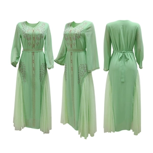 Detail of light green Kaftan dress showing intricate silver beadwork and mesh stitching